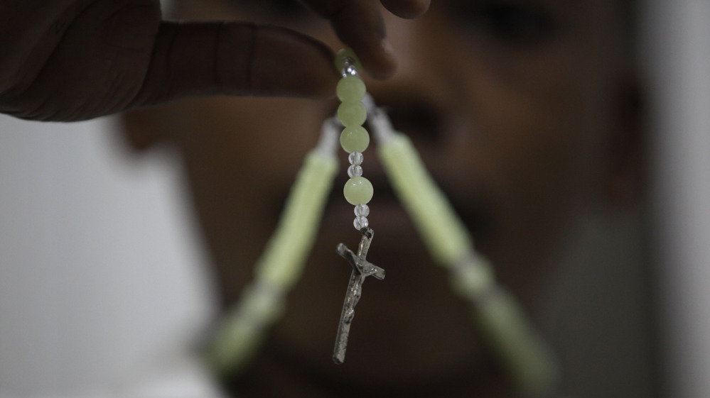 A child prays with his rosary at a Catholic church in Lagos, Nigeria, on Monday. In Africa, where the Catholic Church continues to grow, worshippers and clergy greeted Pope Benedict XVI's announcement that he planned to resign with hopes that the continent would see one of its own rise to lead the faithful.