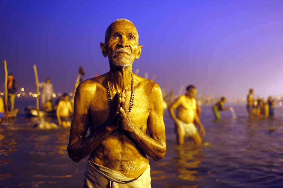 A Hindu devotee prays after a holy dip at the Sangam, the confluence of three holy rivers — the Ganges, the Yamuna and the mythical Saraswati — during the Kumbh Mela festival in Allahabad, India, on Sunday.