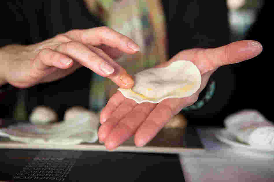 The dumpling dough circle is brushed with egg yolk in a "half-moon" pattern along the top edge, which is critical to holding the dumpling together when it cooks. "Your dumpling doesn't have to look perfect. As long as its properly sealed, it will cook up just as good as any other," says Drewno.