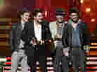Mumford & Sons (from left: Ben Lovett, Marcus Mumford, Ted Dwane and Winston Marshall) accept the award for album of the year at the Grammy Awards on Sunday night.