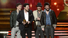 Mumford & Sons (from left: Ben Lovett, Marcus Mumford, Ted Dwane and Winston Marshall) accept the award for album of the year at the Grammy Awards on Sunday night. Mumford & Sons (from left: Ben Lovett, Marcus Mumford, Ted Dwane and Winston Marshall) accept the award for album of the year at the Grammy Awards on Sunday night.
