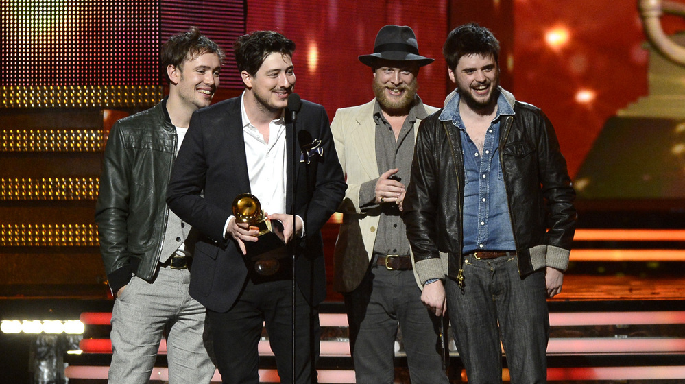 Mumford & Sons (from left: Ben Lovett, Marcus Mumford, Ted Dwane and Winston Marshall) accept the award for album of the year at the Grammy Awards on Sunday night.