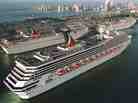 In a photo from 1999, the Carnival Cruise line Carnival Triumph, foreground, arrives in Miami. Measuring 893 feet in length, the ship has been adrift in the Gulf of Mexico for more than 24 hours, after a fire hit its engines.