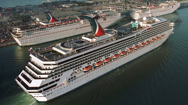 In a photo from 1999, the Carnival Cruise line Carnival Triumph, foreground, arrives in Miami. Measuring 893 feet in length, the ship has been adrift in the Gulf of Mexico for more than 24 hours, after a fire hit its engines.