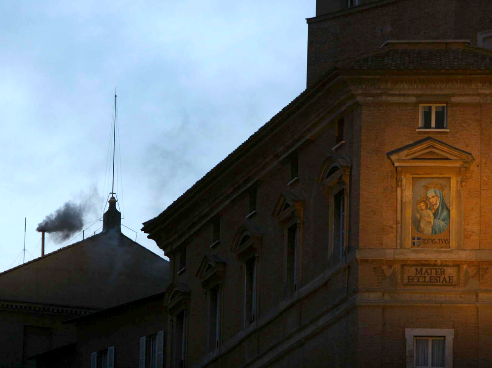Black smoke rises from the chimney of the Sistine Chapel on April 18, 2005. Black smoke signaled that the cardinals sequestered inside had failed to elect a new pope, after the death of Pope John Paul II.