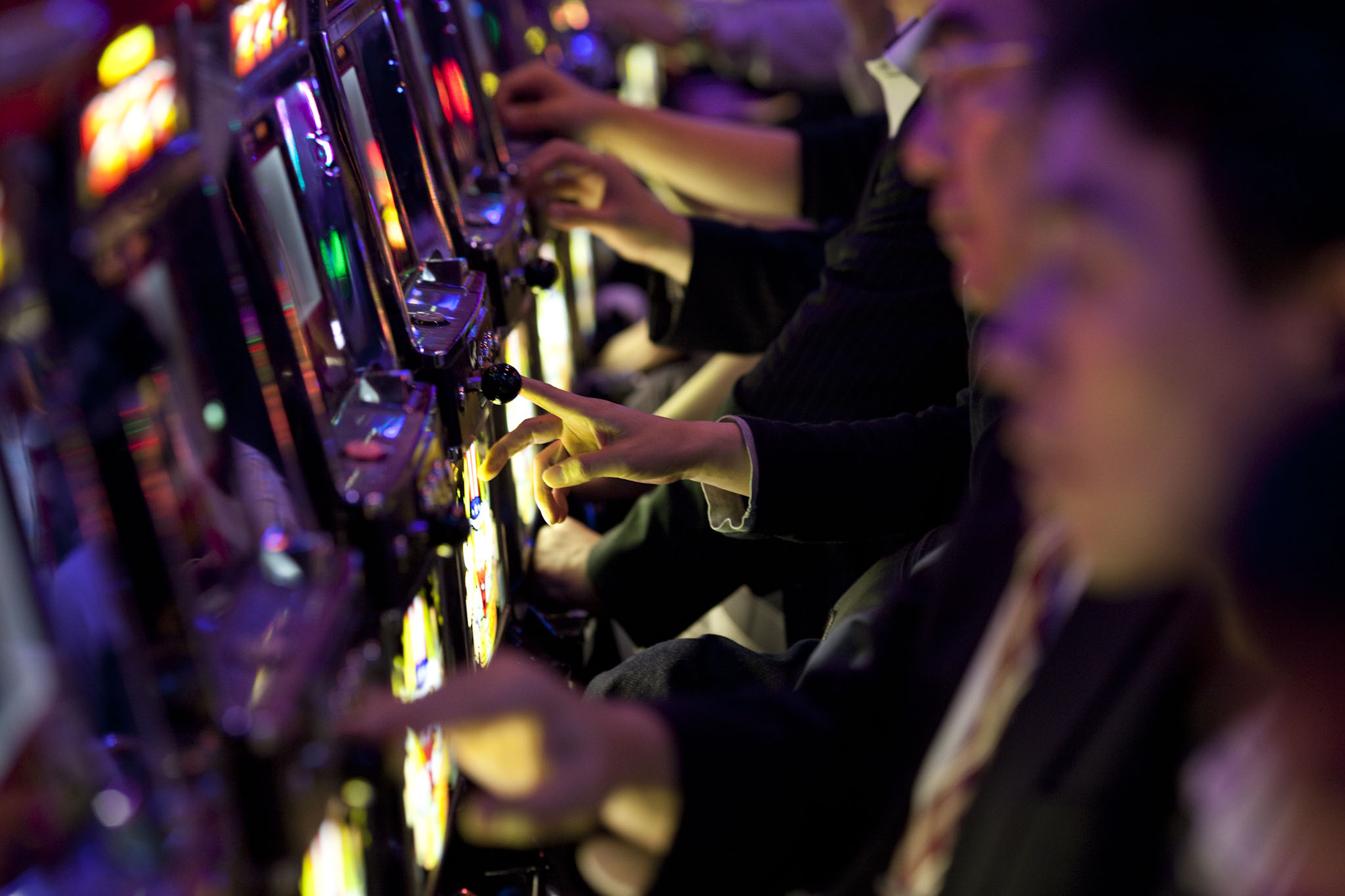 Japanese businessmen play pachinko after work in Tokyo. Japanese white-collar workers, also known as 