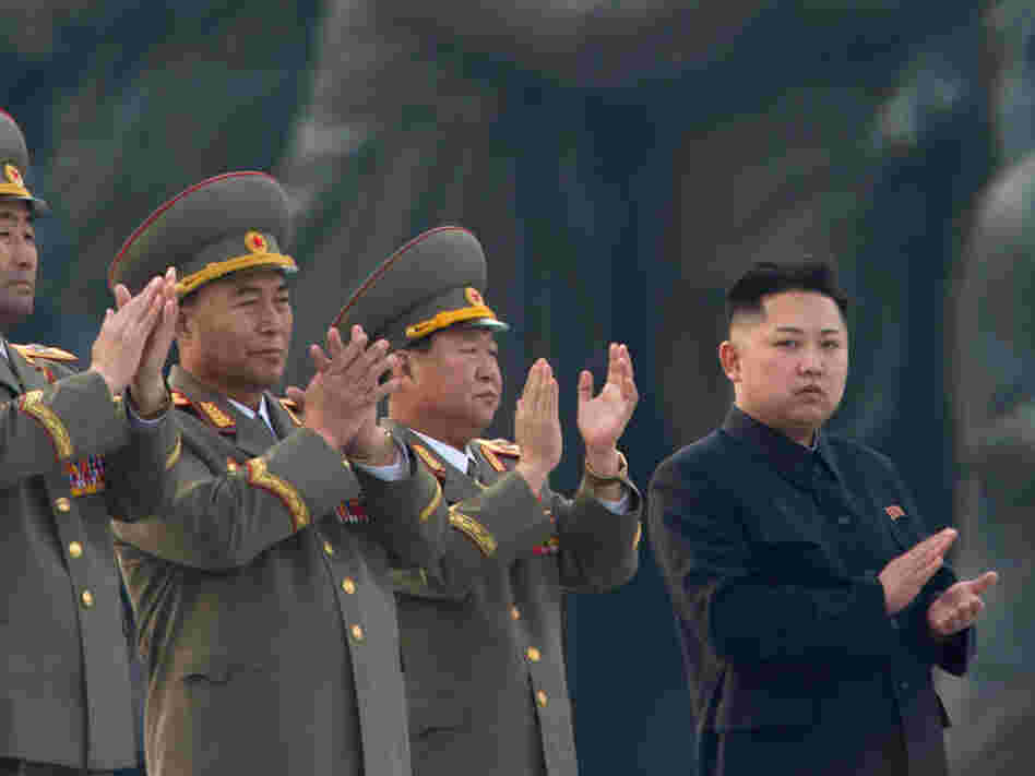 North Korean leader Kim Jong Un (right) claps during a ceremony unveiling statues honoring his grandfather and father, Kim Il Sung and Kim Jong Il, respectively, in Pyongyang last April.