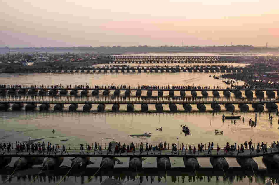 Pilgrims make their way over pontoon bridges.