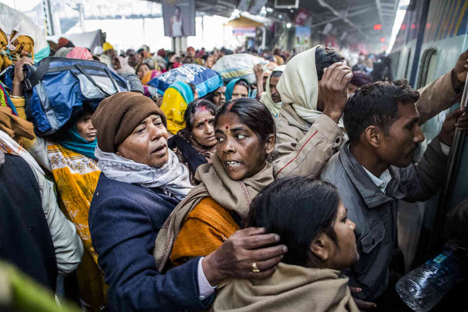 Hindu devotees cram as they board their train Monday at Allahabad train station, the site of Sunday's stampede. Thirty-seven people were killed in the stampede.