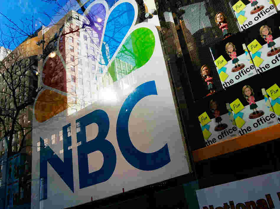 An NBC store is seen through a window reflecting Rockefeller Center in New York City. Comcast, the nation's largest cable company, has owned 51 percent of NBCUniversal since 2011.