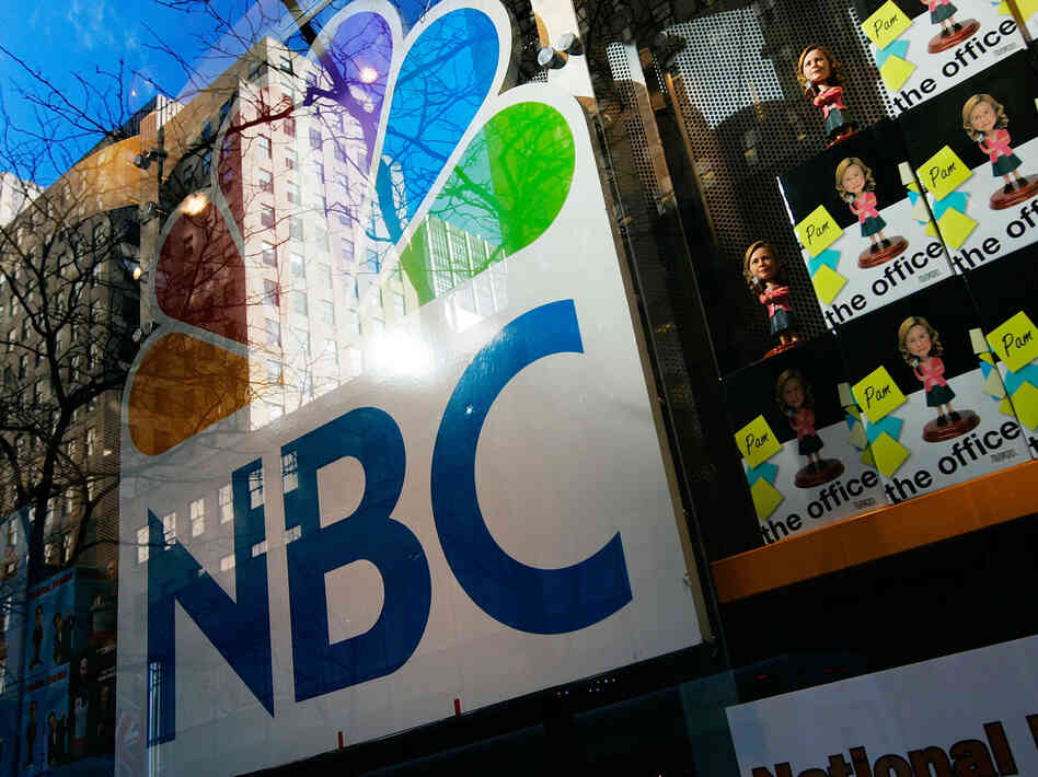 An NBC store is seen through a window reflecting Rockefeller Center in New York City. Comcast, the nation's largest cable company, has owned 51 percent of NBCUniversal since 2011.