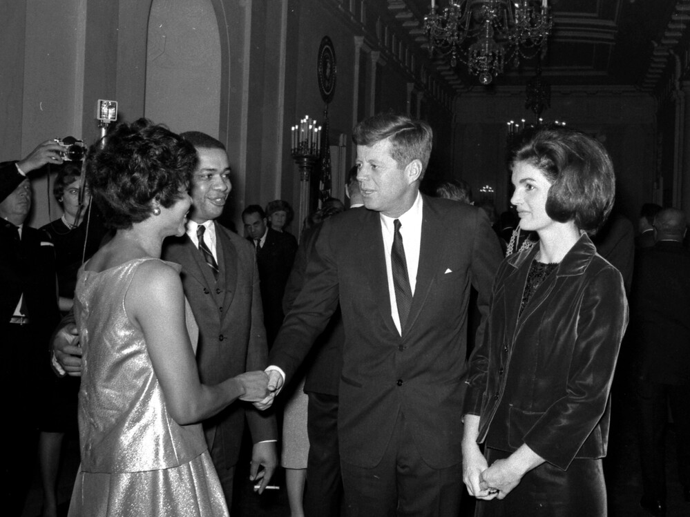 President and Mrs. Kennedy greet Clarence C. Feurgeson Jr., counsel to the Civil Rights Commission, and his wife, at the White House reception.