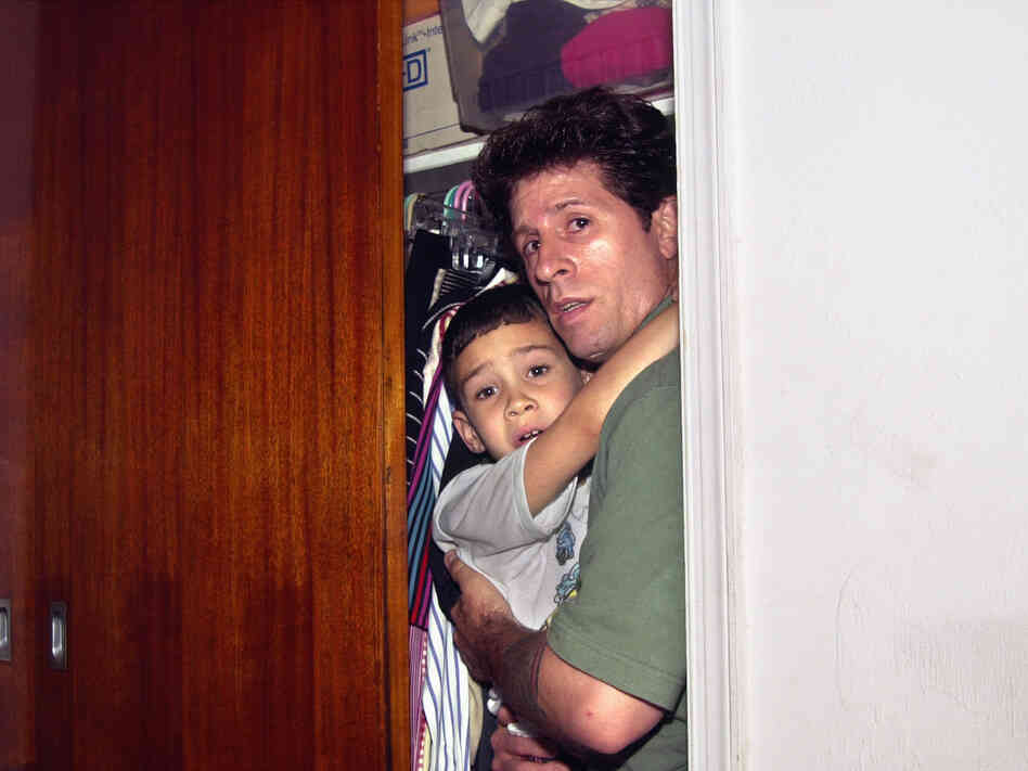Fisherman Donato Dalrymple holds 6-year-old Elian Gonzalez inside a bedroom closet moments before federal agents entered the bedroom on April 22, 2000, and seized the boy to reunite him with his father in Washington.