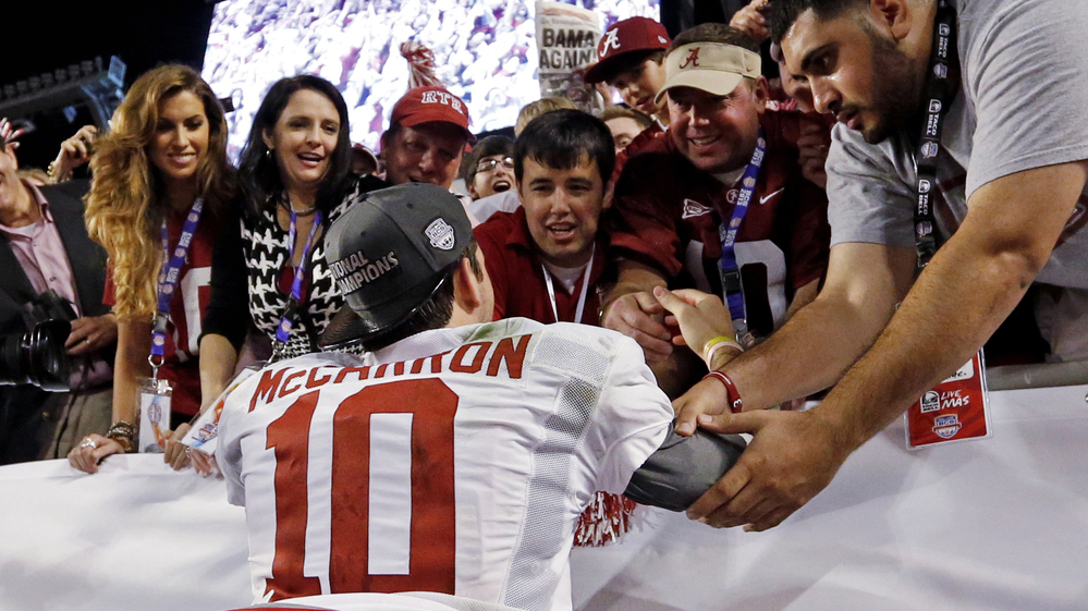 Katherine Webb (left), the girlfriend of Alabama quarterback A.J. McCarron, and McCarron's mother, Dee Dee Bonner (second from left), watch McCarron celebrate after the BCS National Championship college football game on Jan. 7. Webb was caught on camera and announcer Brent Musburger enthusiastically remarked that quarterbacks "get all the good-looking women." ESPN later apologized.