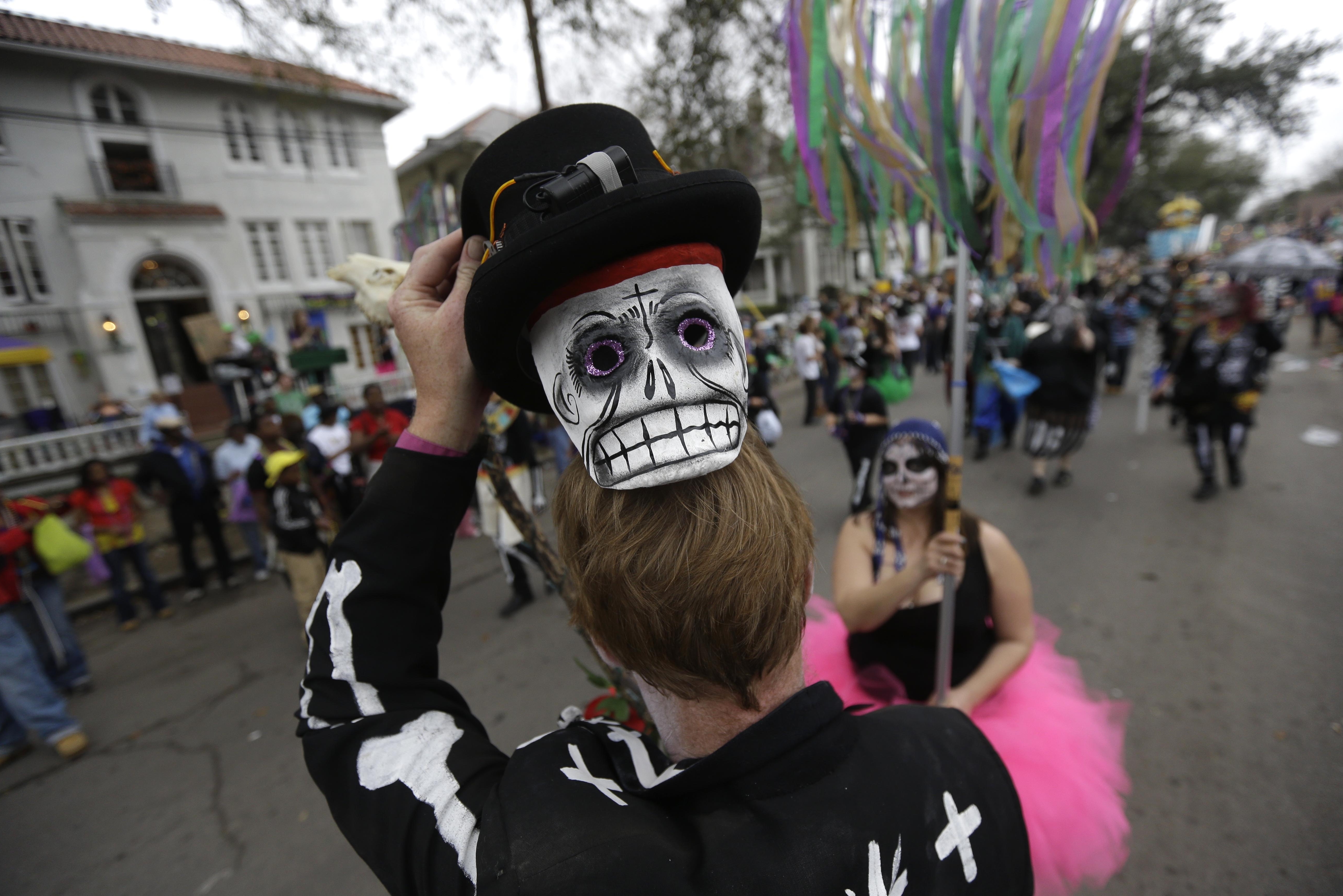 Sunday: A masked reveler in the Krewe of Okeanos parade.