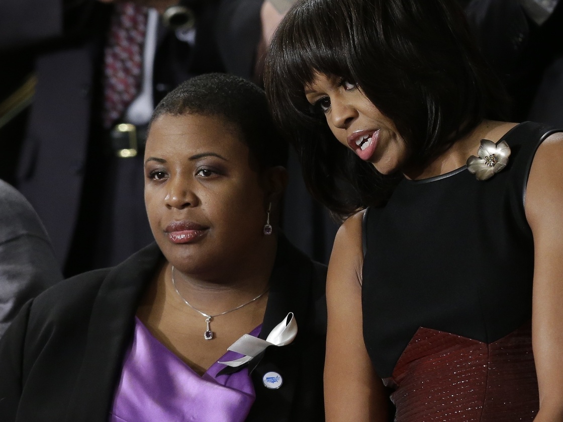 First lady Michelle Obama stands with Cleopatra Cowley-Pendleton, whose daughter was recently shot and killed in Chicago, at the State of the Union address.