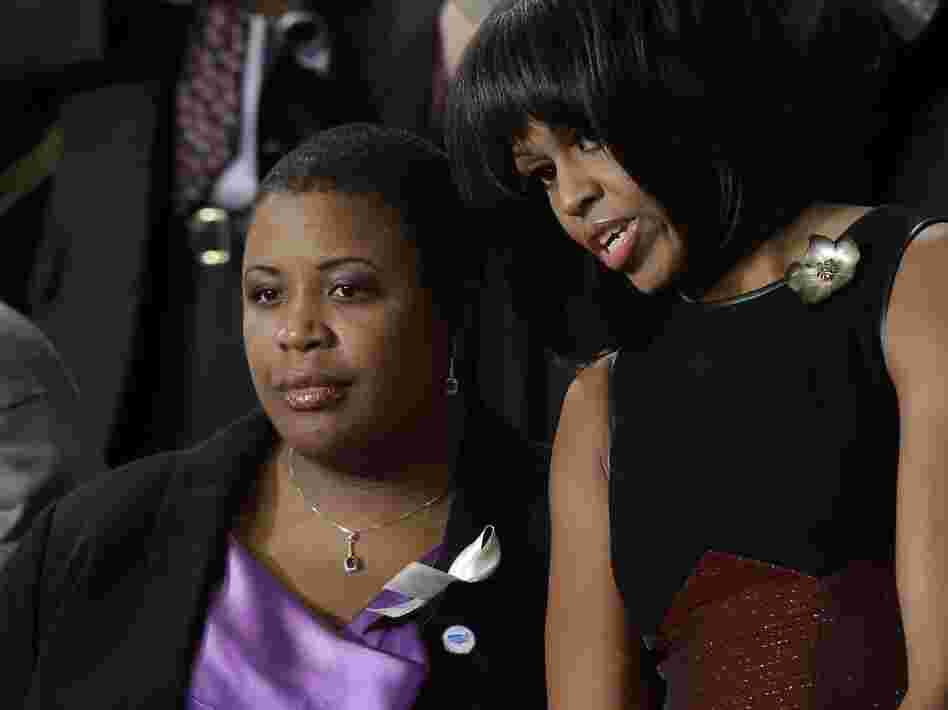 First lady Michelle Obama stands with Cleopatra Cowley-Pendleton, whose daughter was recently shot and killed in Chicago, at the State of the Union address.