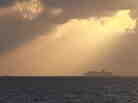 Two tugs tow and steer the Carnival Triumph cruise ship in the Gulf of Mexico Tuesday. The ship is headed to Mobile, Ala., after an engine room fire on Sunday.