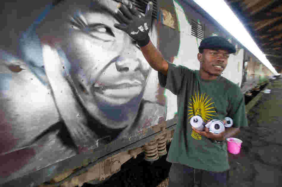 Kenyan graffiti artists received permission from the Rift Valley Railway to spray-paint a 10-car commuter train with messages of peace. Here, true to his name, Swift9 finishes his piece before anyone else: a portrait of Nobel Peace Prize winner Wangari Maathai.
