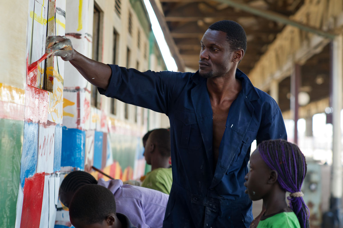 Stephen Onyango Owino paints the train with the help of kids from 