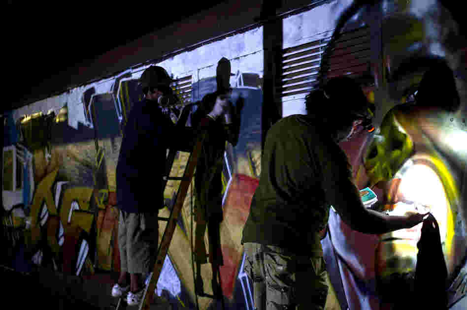 The artists work into the night to finish painting the peace train before it leaves for Kibera the next morning at 6 a.m.