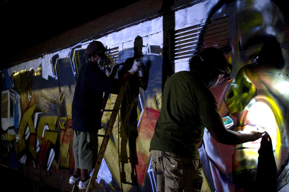 The artists work into the night to finish painting the peace train before it leaves for Kibera the next morning at 6 a.m.