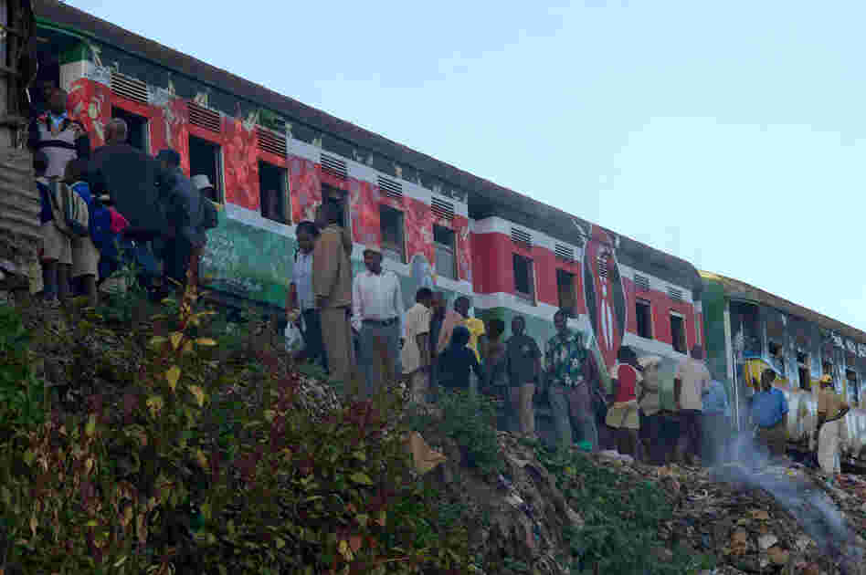 Morning commuters at Kibera train station board a train that became colorful overnight.