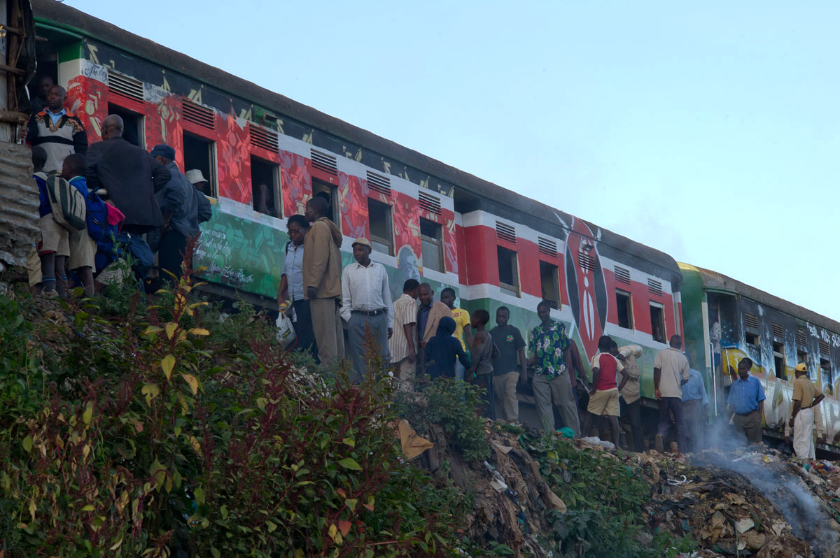 Morning commuters at Kibera train station board a train that became colorful overnight.