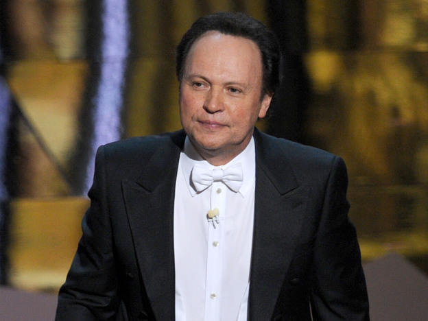 Billy Crystal hosts the 84th Annual Academy Awards in 2012. Writing jokes for hosts is a tricky game, says longtime joke writer Dave Boone.