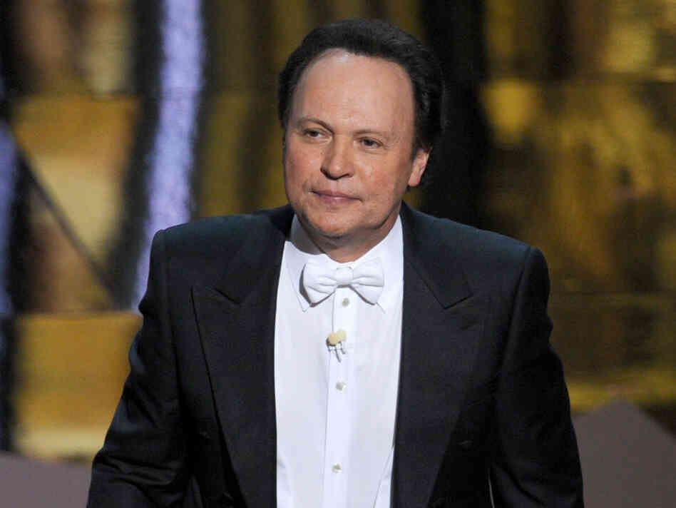 Billy Crystal hosts the 84th Annual Academy Awards in 2012. Writing jokes for hosts is a tricky game, says longtime joke writer Dave Boone.