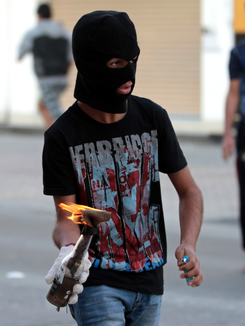 A Bahraini anti-government protester prepares to throw a Molotov cocktail at riot police during clashes in Malkiya village, Bahrain, on Jan. 7.