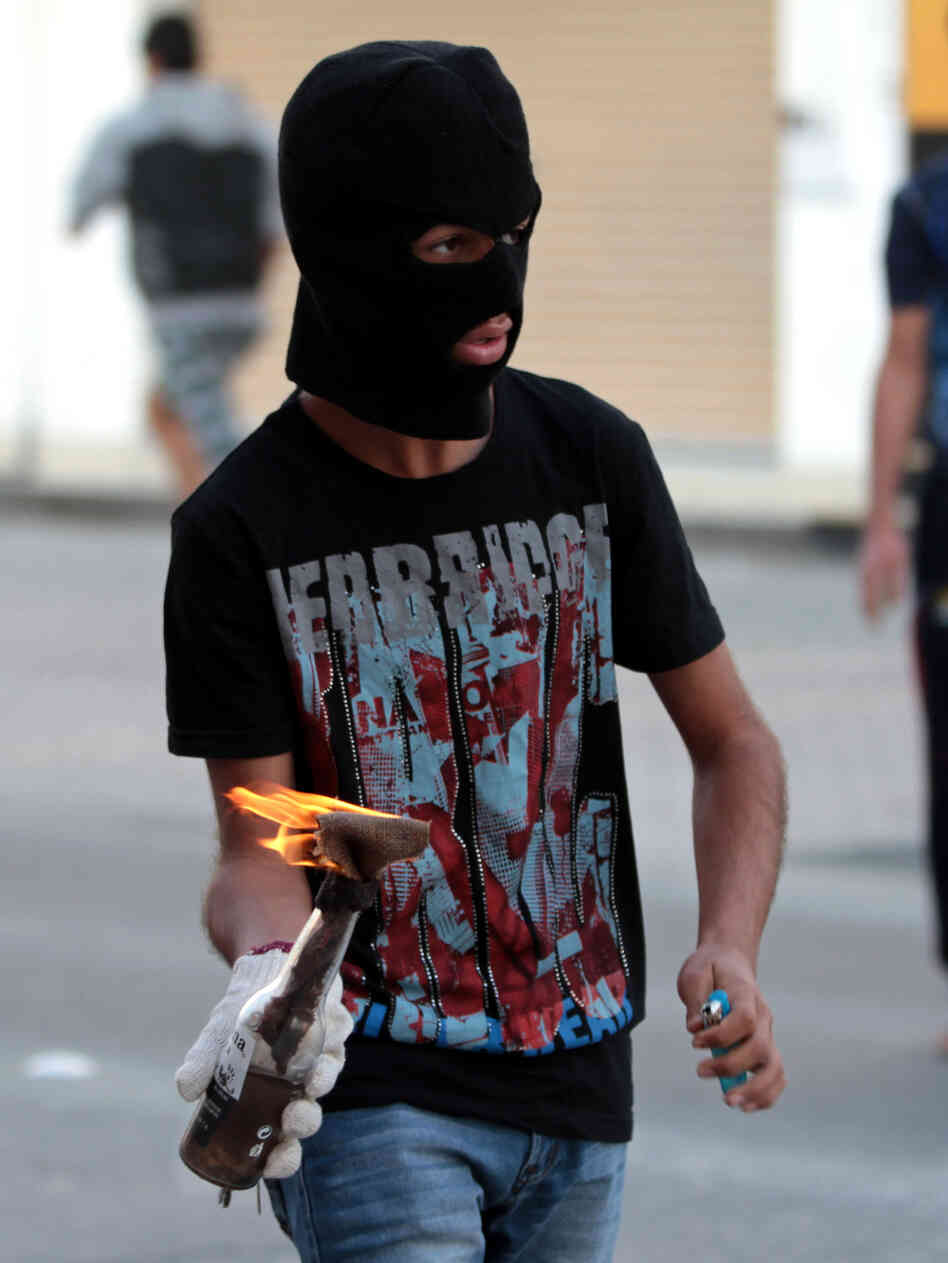 A Bahraini anti-government protester prepares to throw a Molotov cocktail at riot police during clashes in Malkiya village, Bahrain, on Jan. 7.
