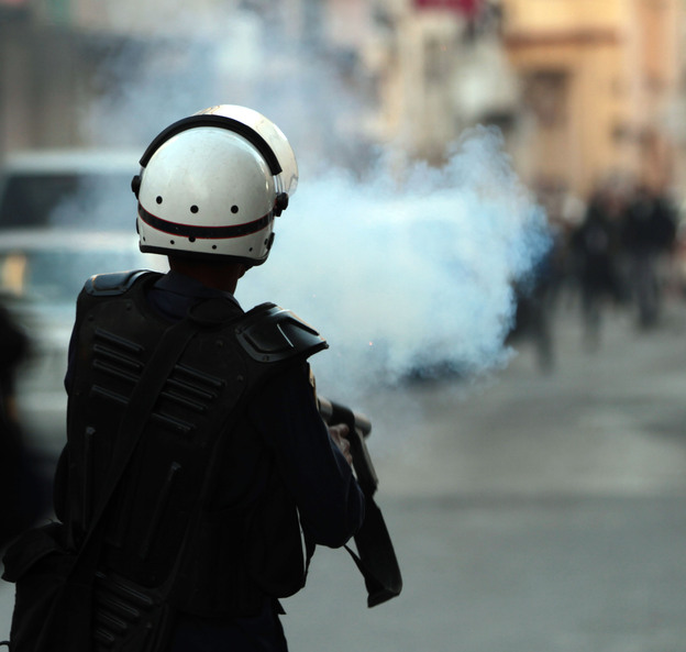 Riot police fire tear gas at anti-government protesters in Manama on Jan. 18.