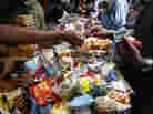 Shoppers buy smuggled counterfeit drugs at the Adjame market in Abidjan, Ivory Coast, in 2007.