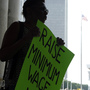 Wendy Brown of Schenectady, N.Y., holds a sign before an Occupy Albany rally pushing for a raise in New York's minimum wage on May 29, 2012. Wendy Brown of Schenectady, N.Y., holds a sign before an Occupy Albany rally pushing for a raise in New York's minimum wage on May 29, 2012.
