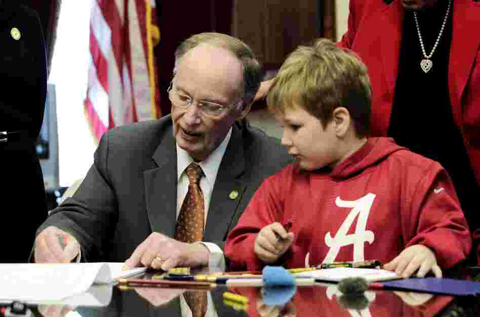 Ala. Gov. Robert Bentley colors with 6-year-old Ethan in a visit to the governor's office on Wednesday, Feb. 13, 2013.