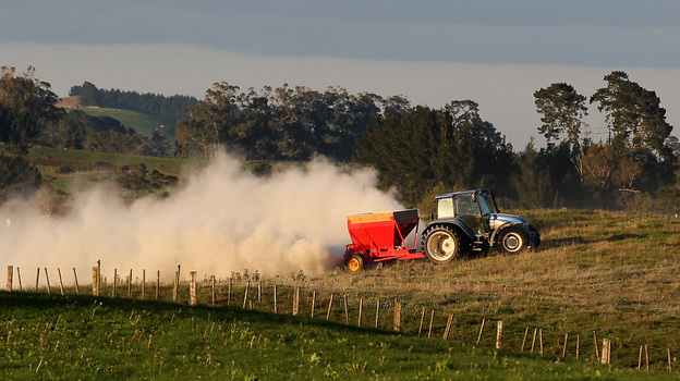 A tractor spreads fertilizer at a dairy farm in Morrinsville, New Zealand. (Getty Images)