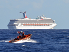 Coast Guard patrols near the cruise ship Carnival Triumph in the Gulf of Mexico on Monday. The Carnival Triumph lost propulsion power after an engine room fire a day earlier. Coast Guard patrols near the cruise ship Carnival Triumph in the Gulf of Mexico on Monday. The Carnival Triumph lost propulsion power after an engine room fire a day earlier.