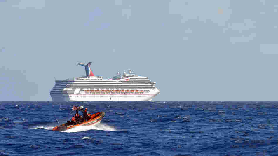 Coast Guard patrols near the cruise ship Carnival Triumph in the Gulf of Mexico on Monday. The Carnival Triumph lost propulsion power after an engine room fire a day earlier.
