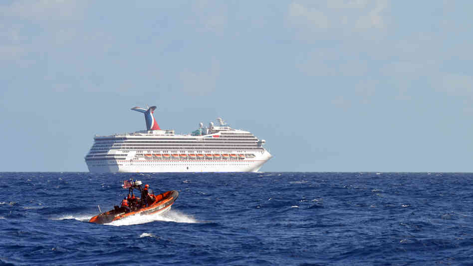 Coast Guard patrols near the cruise ship Carnival Triumph in the Gulf of Mexico on Monday. The Carnival Triumph lost propulsion power after an engine room fire a day earlier.