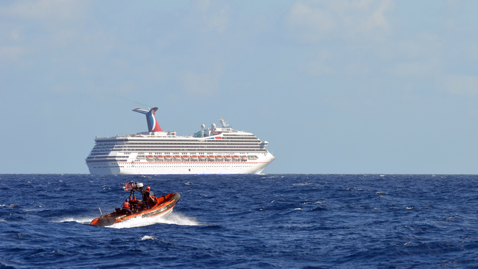 Coast Guard patrols near the cruise ship Carnival Triumph in the Gulf of Mexico on Monday. The Carnival Triumph lost propulsion power after an engine room fire a day earlier.