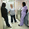 Peggy Renzi (middle) talks with her teammates Erika Hersey (left) and Erica Webster. The three are part of a team of nurses in the Bowie Health Center emergency room in Bowie, Md., who are working together to lose weight.