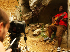 Singer-songwriter Amos Dolce on the set of the video for his song "Haiti, Haiti," which Konbit Mizik produced. Singer-songwriter Amos Dolce on the set of the video for his song "Haiti, Haiti," which Konbit Mizik produced.