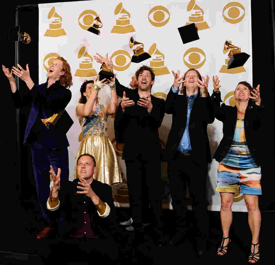 Arcade Fire's members with their album of the year Grammys.