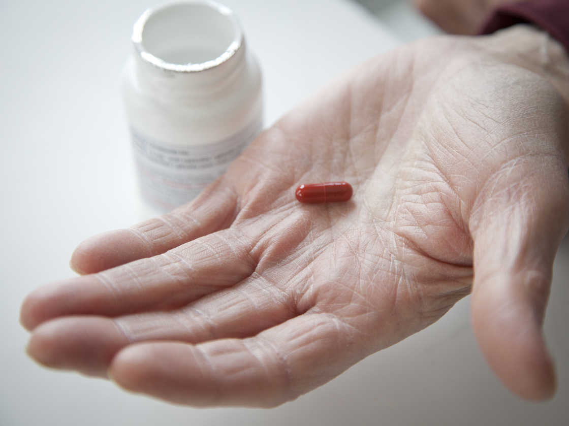 Don Wright shows the drug pomalidomide, which he has been taking as a participant in a clinical trial. Pomalidomide was recently approved by the FDA approved for treatment of multiple myeloma.