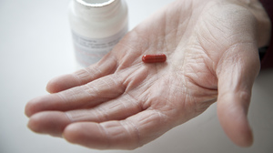 Don Wright shows the drug pomalidomide, which he has been taking as a participant in a clinical trial. Pomalidomide was recently approved by the FDA approved for treatment of multiple myeloma.