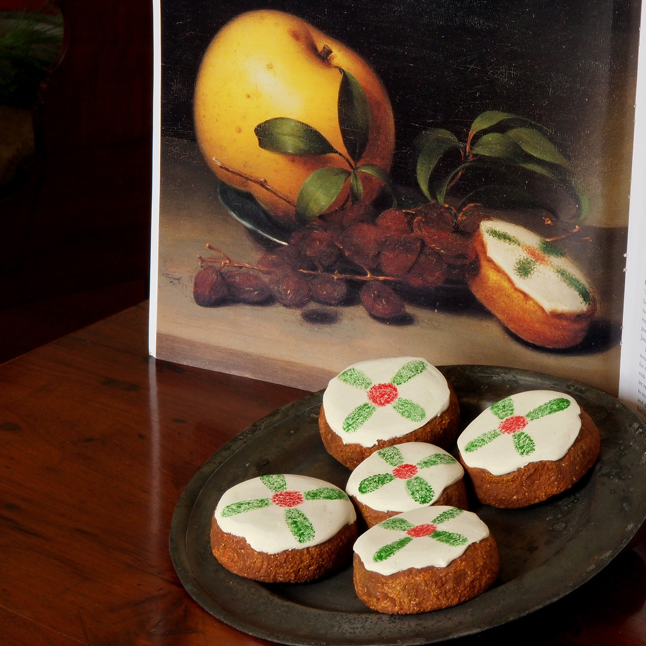 Cakes displayed with a reproduction of Raphaelle Peale's Still Life with Cake, from circa 1822