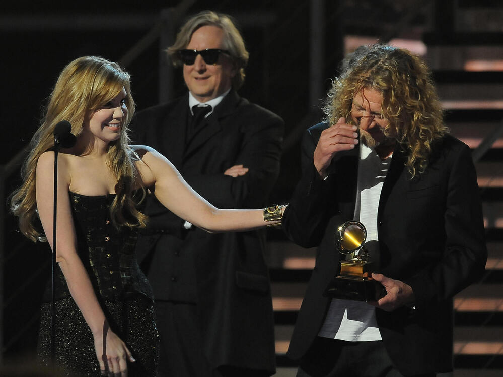 Alison Krauss (left) and Robert Plant (right) with producer T Bone Burnett accept the Album of the Year award at the 51st Grammy Award ceremony in 2009.