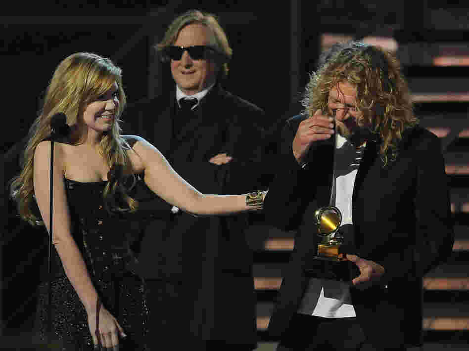 Alison Krauss (left) and Robert Plant (right) with producer T Bone Burnett accept the Album of the Year award at the 51st Grammy Award ceremony in 2009.