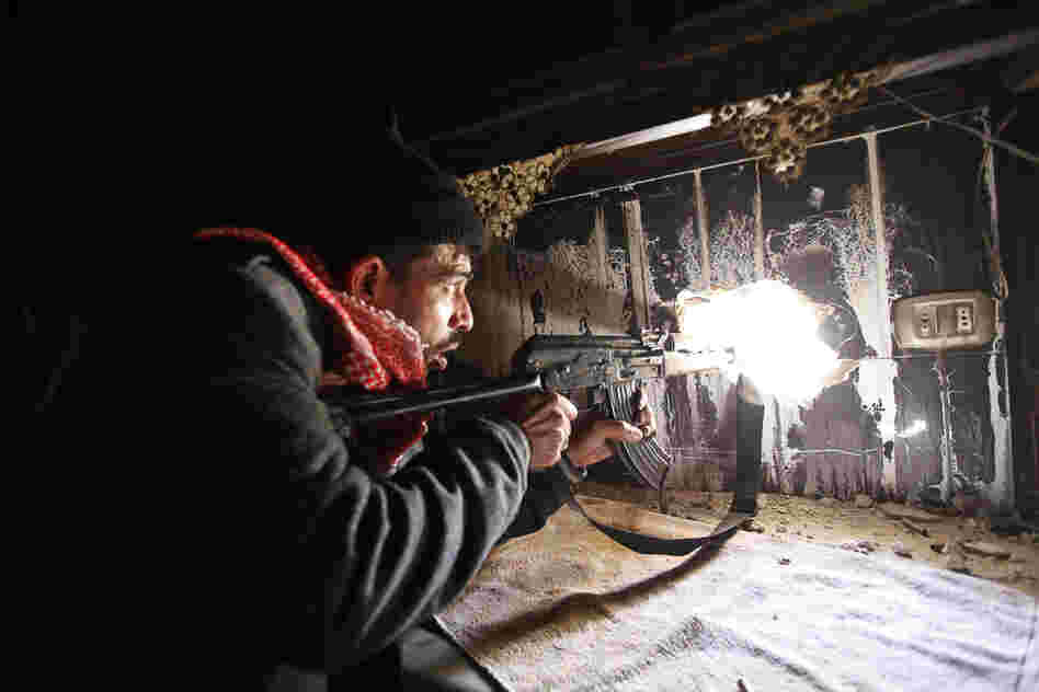 All of the photos in this slideshow were taken by Nour Kelze but published under the pseudonym Zain Karam. Kelze recently decided to begin publishing her photos under her real name. Here, a Free Syrian Army fighter takes up position inside a burned-out room in Aleppo, Syria, in November 2012.